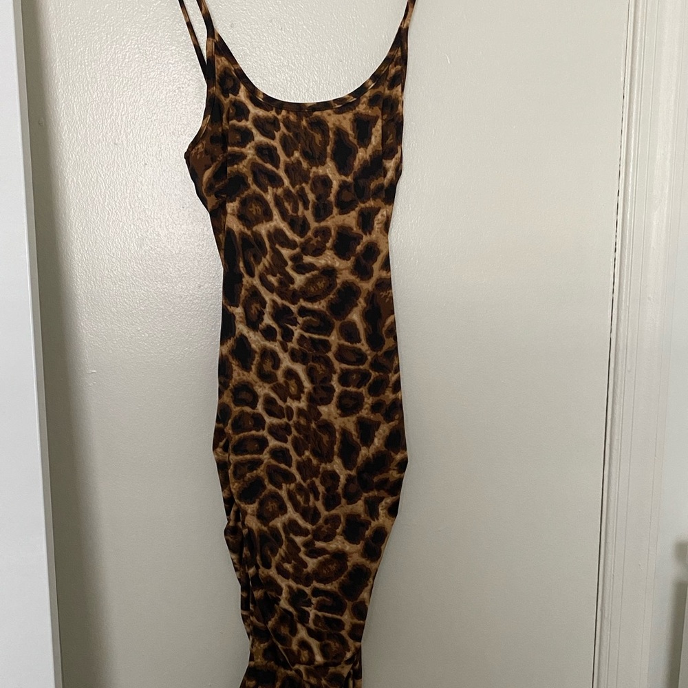 A beautiful leopard print body con dress, from Mad-rags and in a size small.